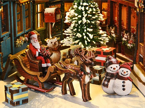 Arrenslee van de kerstman met rendier en sneeuwpoppen